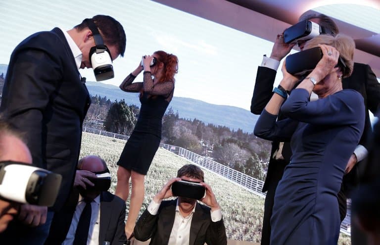 A group of people wearing vr headsets at an event, but U.S. Sees Protectionism.